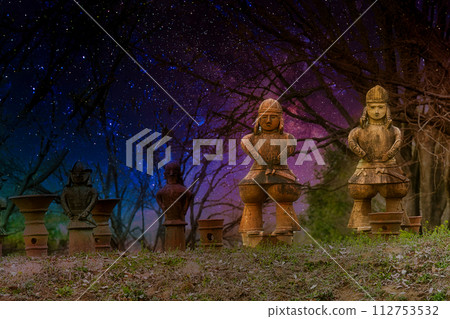 Night scene with clay clay placed on top of an ancient tomb made of stones Night scene with clay clay placed on top of an ancient tomb made of stones 112753532