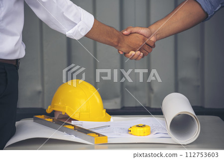 Close up warehouse worker shakehand together. Engineer man hands partnership. Diversity Coworker Men logistics Warehouse teams handshake. Multiracial Support team greeting person teamwork colleagues 112753603