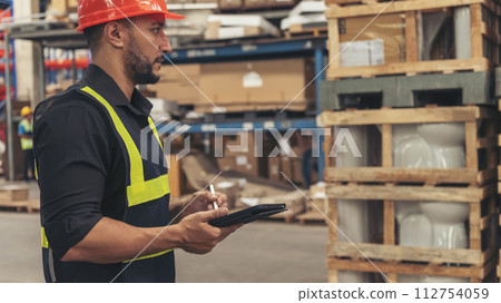 Hispanic men hands touch smart tablet Warehouse management logistics counting checking products on inventory shelf. Engineer Man hands worker check stock control in distribution storage checklist 112754059