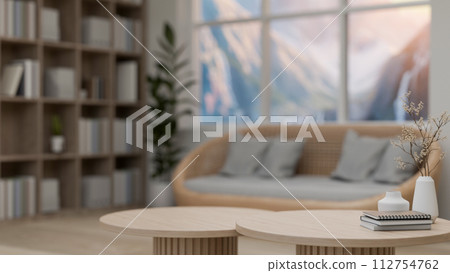 A close-up image of a minimal wooden coffee table in a comfortable, Scandinavian living room. 112754762