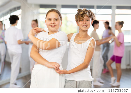 Girl dances Latin dance with male boy teen partner during choreography lesson 112755967