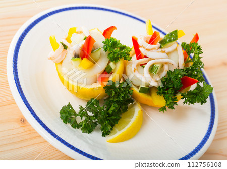 Salad with calamaries, cucumbers, bell pepper in lemon 112756108