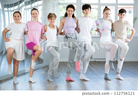 Boys and girls teenagers choreography students perform Irish dance with female teacher 112756121