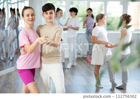 Girl dances waltz with male boy teen partner during choreography lesson Girl dances waltz with male boy teen partner during choreography lesson 112756302