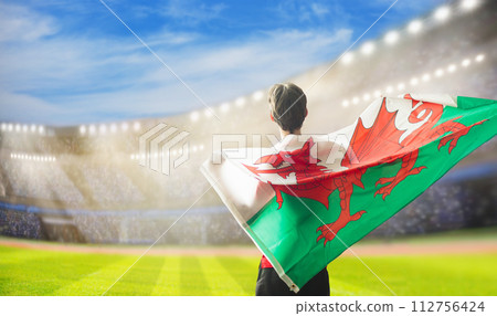 Wales supporters. Welsh football fans on stadium. 112756424