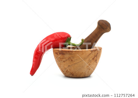 Red chili pepper and wooden pestle with mortar 112757264