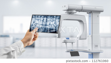 Dentist analyze digital x-ray film from scanner machine Dentist analyze digital x-ray film from scanner machine 112761060