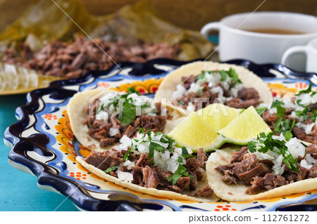 Mexican barbacoa beef tacos and beef barbacoa and barbacoa consommé 112761272