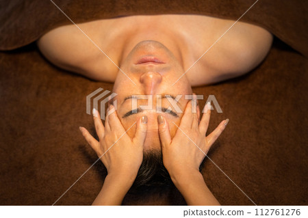 A man receiving facial beauty treatment at a men's beauty salon A man receiving facial beauty treatment at a men's beauty salon 112761276