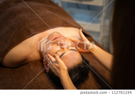 A man receiving facial beauty treatment at a men's beauty salon A man receiving facial beauty treatment at a men's beauty salon 112761284