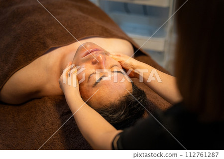 A man receiving facial beauty treatment at a men's beauty salon A man receiving facial beauty treatment at a men's beauty salon 112761287