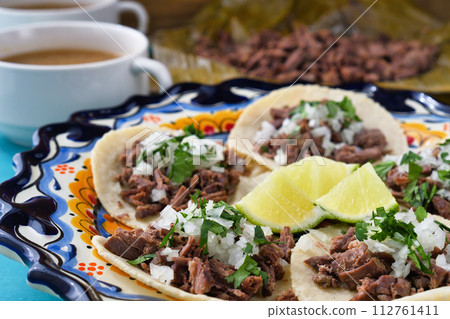 Mexican barbacoa beef tacos and beef barbacoa and barbacoa consommé Mexican barbacoa beef tacos and beef barbacoa and barbacoa consommé 112761411