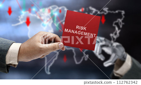 Business hand holding a note with risk management text 112762342