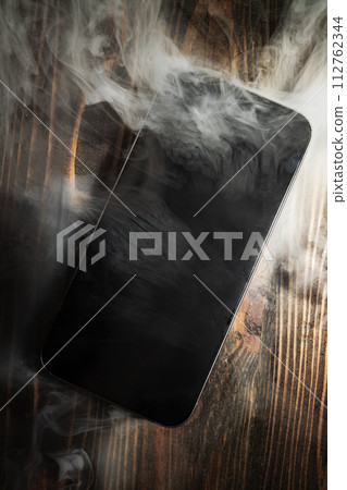A broken mobile phone smoked 112762344