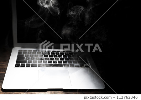 A broken laptop smoked A broken laptop smoked 112762346