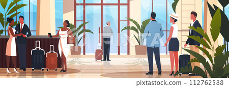 tourists with luggage departing from business trip standing at reception desk in hotel lobby recreation travel check-in concept tourists with luggage departing from business trip standing at reception desk in hotel lobby recreation travel check-in concept 112762588