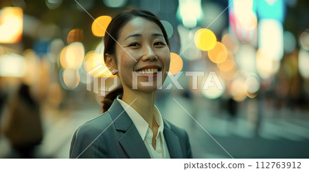 Smiling businesswoman in city at night 112763912