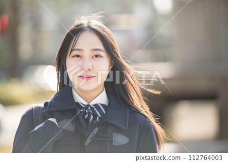 High school girl looking shy at the camera High school girl looking shy at the camera 112764003