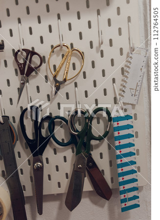 sewing paraphernalia, scissors and fabric for work, hobby sewing and embroidery 112764505