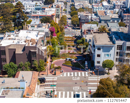 Panoramic view of aerial Lombard Street, an east west street in San Francisco, California. Famous for steep, one block section with eight hairpin turns. Crookedest, steep hills, sharp curves 112765447