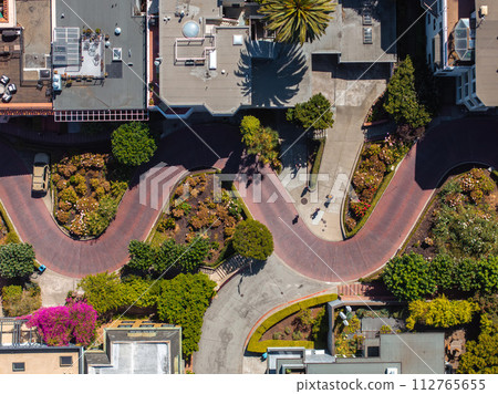 Panoramic view of aerial Lombard Street, an east west street in San Francisco, California. Famous for steep, one block section with eight hairpin turns. Crookedest, steep hills, sharp curves 112765655