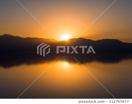 Aerial view over Salton sea in California. Huge lake in the middle of a desert at sunset. 112765657