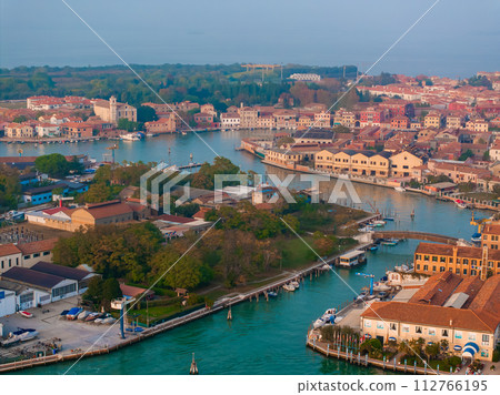 Aerial view of Murano island in Venetian lagoon sea from above, Italy at sunset Aerial view of Murano island in Venetian lagoon sea from above, Italy at sunset 112766195
