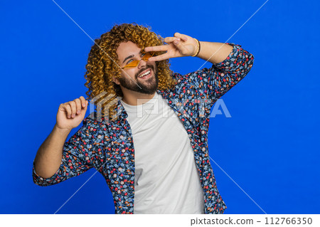 Caucasian stylish man wearing sunglasses dancing celebrating success victory winning success Caucasian stylish man wearing sunglasses dancing celebrating success victory winning success 112766350