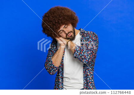 Tired exhausted young man lazy bored lack of sleep, falling asleep taking a break relaxing Tired exhausted young man lazy bored lack of sleep, falling asleep taking a break relaxing 112766448