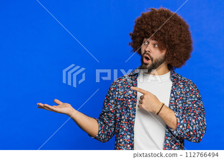 Young man showing pointing at left on blank space place for your advertisement logo Young man showing pointing at left on blank space place for your advertisement logo 112766494