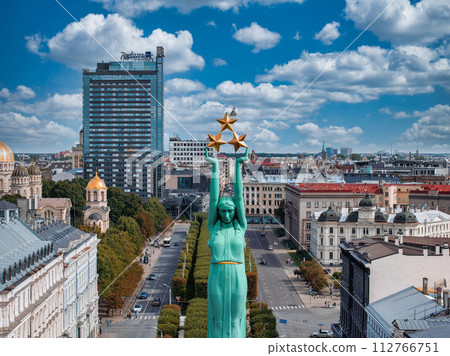 Beautiful sunrise view over Riga by the statue of liberty - Milda in Latvia. The monument of freedom. 112766751