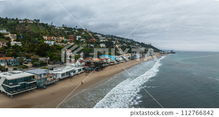 Malibu beach aerial view in California near Los Angeles, USA. Waves hitting the shore near expensive houses in Malibu. Malibu beach aerial view in California near Los Angeles, USA. Waves hitting the shore near expensive houses in Malibu. 112766842