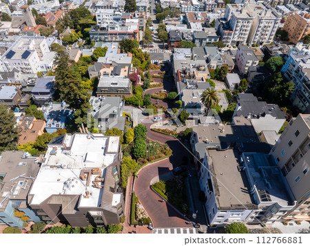 Panoramic view of aerial Lombard Street, an east west street in San Francisco, California. Famous for steep, one block section with eight hairpin turns. Crookedest, steep hills, sharp curves Panoramic view of aerial Lombard Street, an east west street in San Francisco, California. Famous for steep, one block section with eight hairpin turns. Crookedest, steep hills, sharp curves 112766881