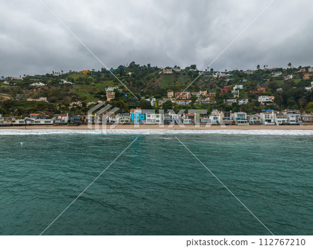 Malibu beach aerial view in California near Los Angeles, USA. Waves hitting the shore near expensive houses in Malibu. 112767210