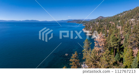 Beautiful aerial view of the Tahoe lake from above in California, USA. Wild forests, fresh air and mountains of California. Beautiful aerial view of the Tahoe lake from above in California, USA. Wild forests, fresh air and mountains of California. 112767213