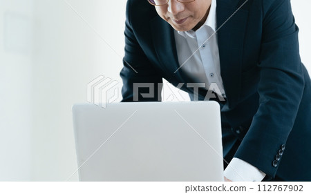 Businessman worried while looking at a computer 112767902