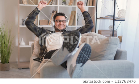 Song joy music device man headphones couch home 112768476
