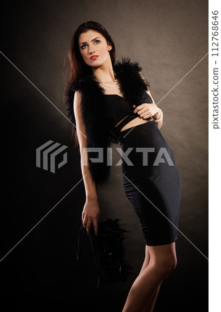 woman evening dress handbag in hand on black 112768646