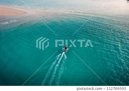 Boat on clear blue water on island Boat on clear blue water on island 112769393