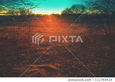 Sunset over the village in early spring Sunset over the village in early spring 112769416