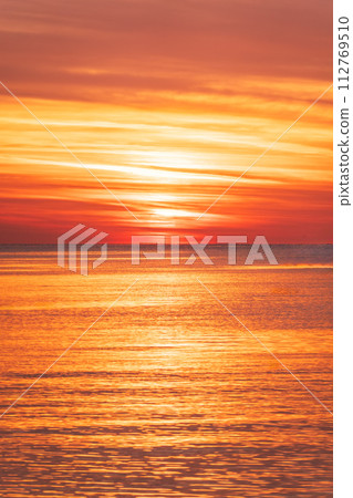 Beautiful red and orange sunrise over the sea. Beautiful red and orange sunrise over the sea. 112769510