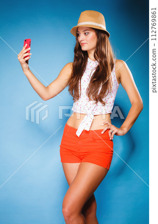 woman taking self picture with smartphone camera woman taking self picture with smartphone camera 112769861