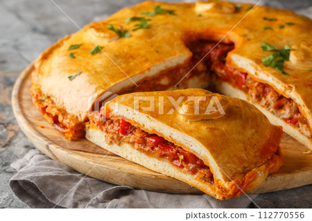 Empanada Gallega Traditional pie stuffed with tuna or meat and vegetables typical from Galicia, Spain closeup on the board. Horizontal Empanada Gallega Traditional pie stuffed with tuna or meat and vegetables typical from Galicia, Spain closeup on the board. Horizontal 112770556