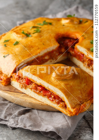 Spanish Empanada Gallega Galician Pork and Pepper Pie closeup on the board. Vertical 112770559