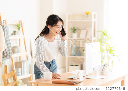 一名年輕女子在遠距辦公期間在客廳工作 112770846