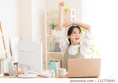 A young woman working from the living room during telework 112770893