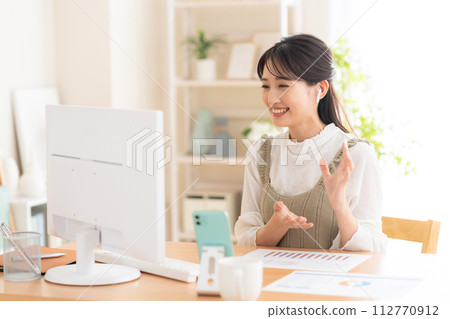 A young woman working from the living room during telework 112770912