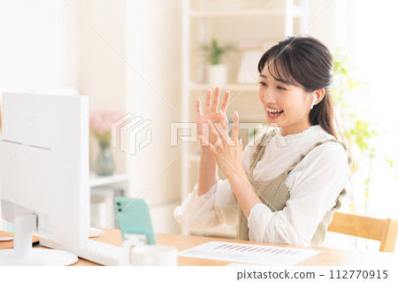 A young woman working from the living room during telework 112770915