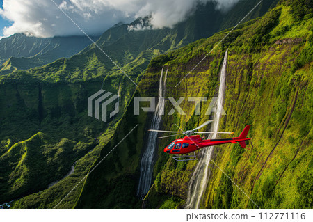 Red helicopter flies close to spectacular waterfalls and mountains, showcasing breathtaking natural scenery 112771116