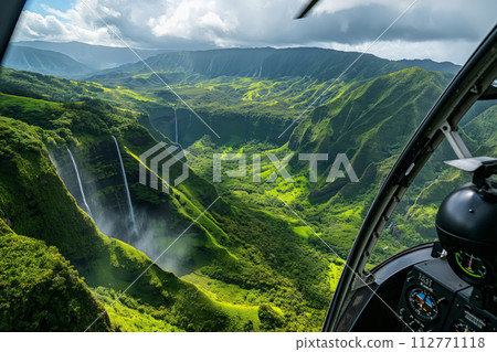 Aerial view from a helicopter cockpit overlooking majestic waterfalls in a lush green valley 112771118